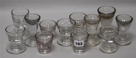 A group of twelve firing glasses tallest 10cm